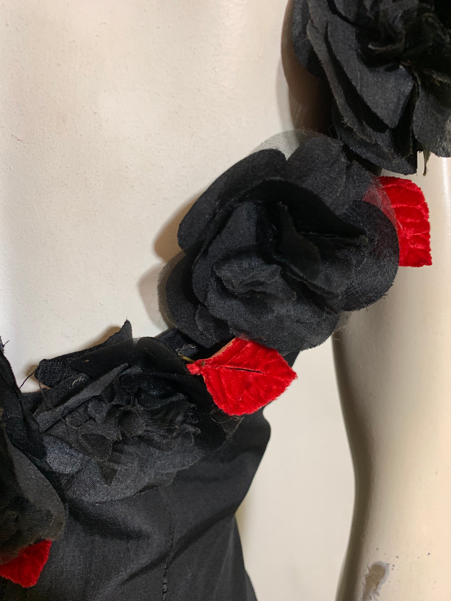 Show Stopping Figure Conscious Sleeveless Black Cocktail Dress with Daring Low Back Trimmed in Black and Red Roses circa 1950s