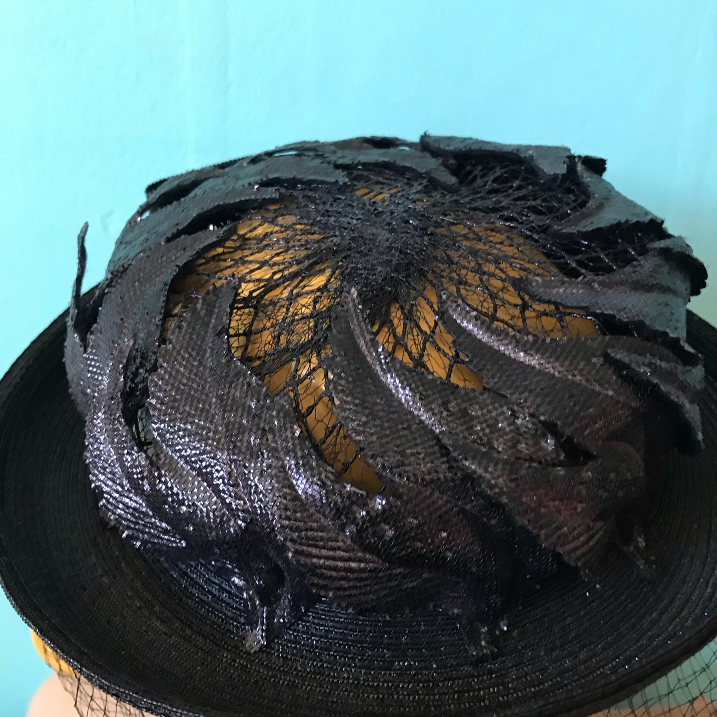 Black Narrow Brimmed Boater Style Hat with Flame Shaped Leaves on Open Top circa 1960s