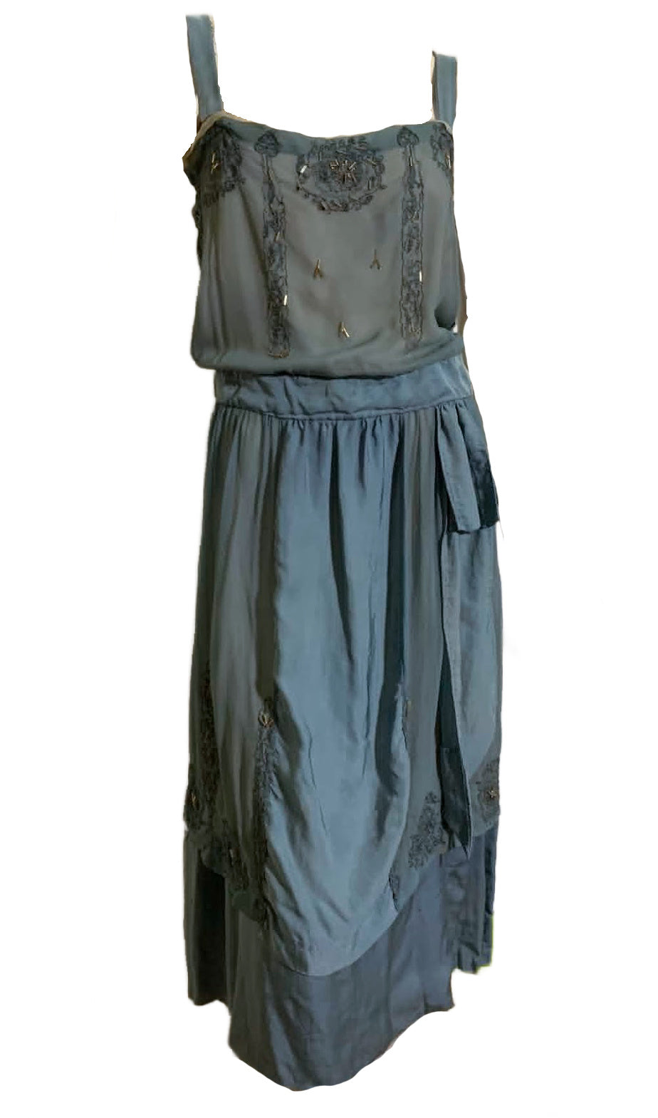Vintage 1920s beaded dress with floral embellishments on a white background