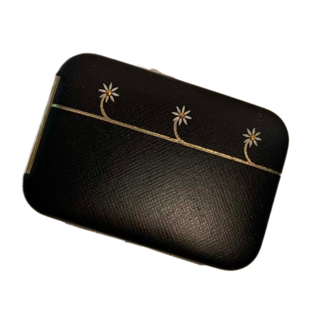 Black pouch with gold accents and floral designs on a white background