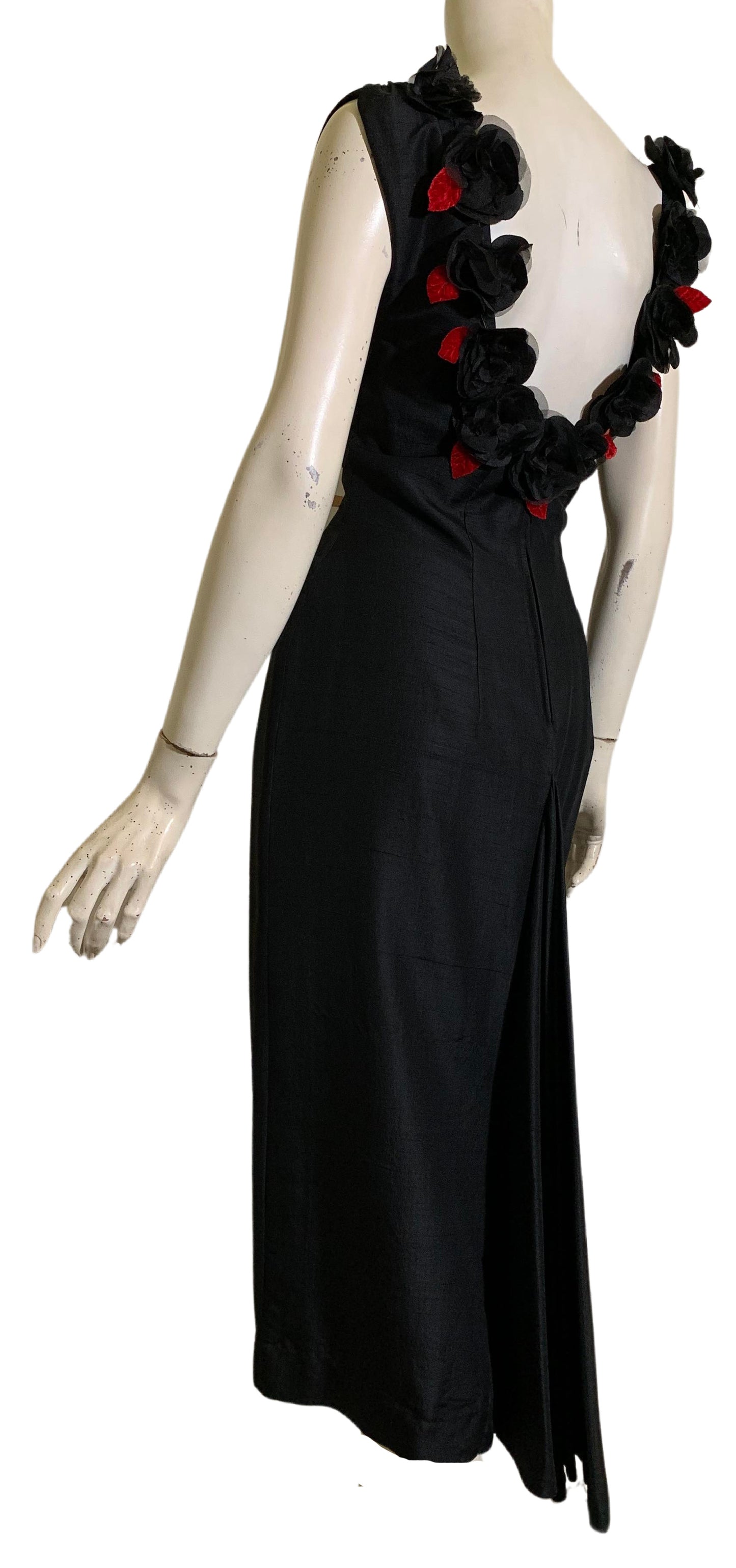 Show Stopping Figure Conscious Sleeveless Black Cocktail Dress with Daring Low Back Trimmed in Black and Red Roses circa 1950s