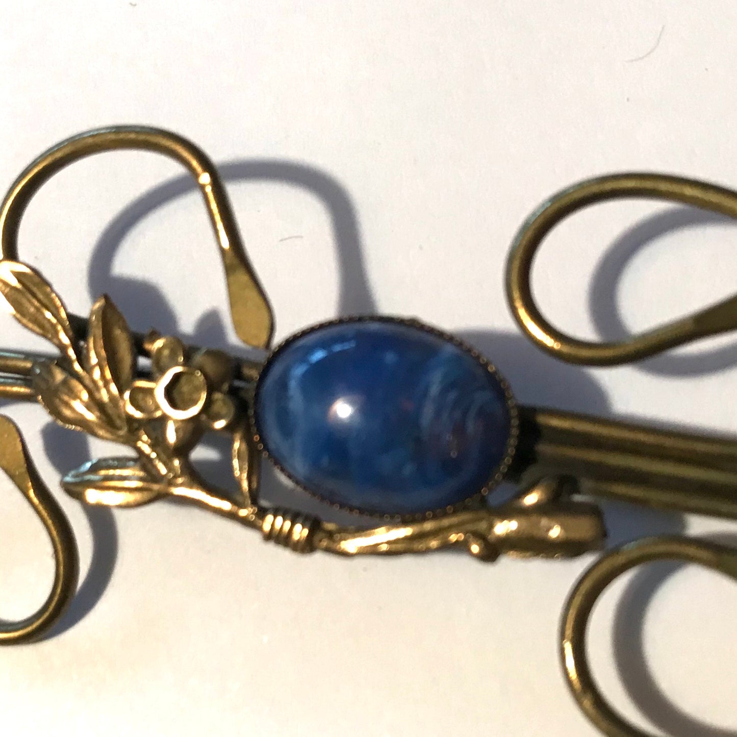 Medusa Inspired Gold Flower and Vine Brooch with Blue Art Glass Center circa 1910s