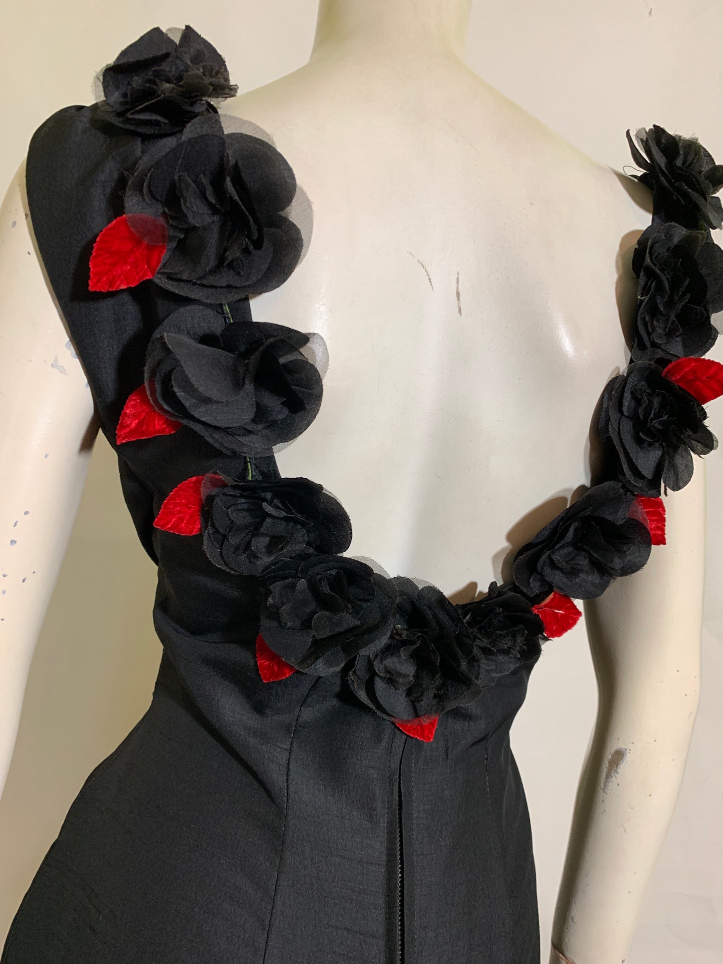 Show Stopping Figure Conscious Sleeveless Black Cocktail Dress with Daring Low Back Trimmed in Black and Red Roses circa 1950s