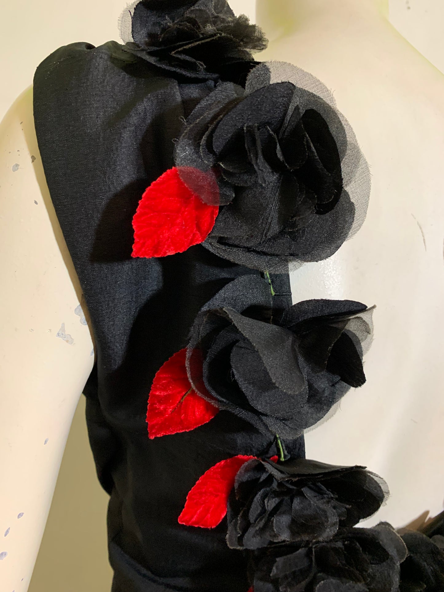 Show Stopping Figure Conscious Sleeveless Black Cocktail Dress with Daring Low Back Trimmed in Black and Red Roses circa 1950s